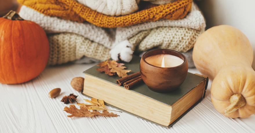 fall scene with candle and sweaters