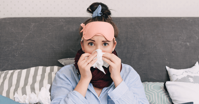 woman sick sitting in bed