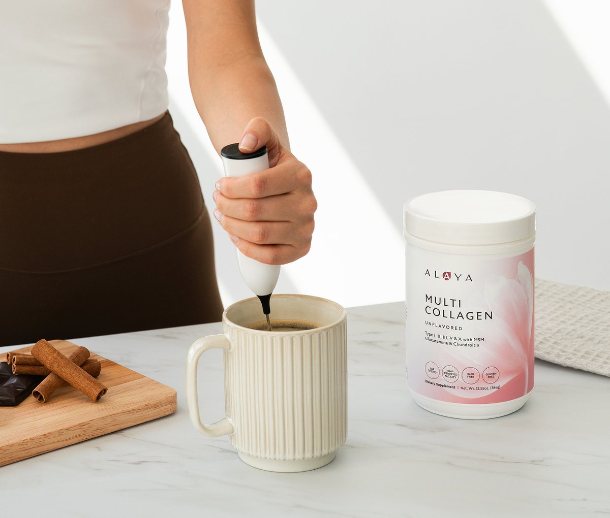 Frothing Alaya Multi Collagen into a cup of coffee